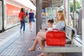 Cute little girl and mother on a railway station. Royalty Free Stock Photo