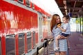 Cute little girl and mother on a railway station. Royalty Free Stock Photo