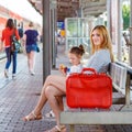 Cute little girl and mother on a railway station. Royalty Free Stock Photo