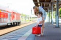 Cute little girl and mother on a railway station. Royalty Free Stock Photo