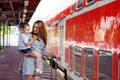 Cute little girl and mother on a railway station. Royalty Free Stock Photo