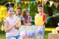 Cute little girl with natural lemonade in park. Summer refreshing drink Royalty Free Stock Photo