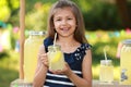 Cute little girl with natural lemonade. Summer refreshing drink