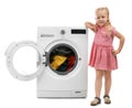 Cute little girl near washing machine with laundry Royalty Free Stock Photo