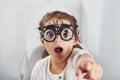 Cute little girl is in ophthalmology clinic with special tool on eyes getting tested Royalty Free Stock Photo