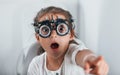 Cute little girl is in ophthalmology clinic with special tool on eyes getting tested Royalty Free Stock Photo