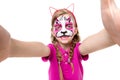 Cute little girl with painted mask on face making selfie Royalty Free Stock Photo