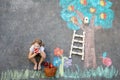 Cute little girl painting with colorful chalks apples harvest from apple tree on asphalt. Cute preschool child with Royalty Free Stock Photo