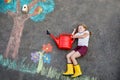 Cute little girl painting with colorful chalks apples harvest from apple tree on asphalt. Cute preschool child with Royalty Free Stock Photo