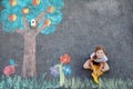 Cute little girl painting with colorful chalks apples harvest from apple tree on asphalt. Cute preschool child with Royalty Free Stock Photo