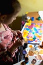 Cute little girl painting with paintbrush and colorful paints Royalty Free Stock Photo