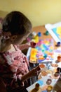 Cute little girl painting with paintbrush and colorful paints Royalty Free Stock Photo