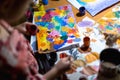 Cute little girl painting with paintbrush and colorful paints Royalty Free Stock Photo