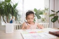 Cute little girl painting picture on home interior background Royalty Free Stock Photo