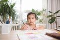 Cute little girl painting picture on home interior background Royalty Free Stock Photo