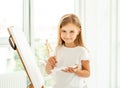 Cute little girl paints on canvas Royalty Free Stock Photo