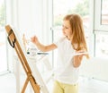 Cute little girl paints on canvas Royalty Free Stock Photo