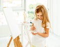 Cute little girl paints on canvas Royalty Free Stock Photo