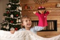 Cute little girl performing puppet show at home