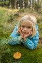 Cute little girl picking mushrooms in summer forest Royalty Free Stock Photo