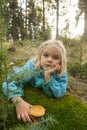 Cute little girl picking mushrooms in summer forest Royalty Free Stock Photo