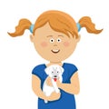 Cute little girl with pigtails holding a white puppy Royalty Free Stock Photo