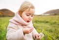 Cute little girl with dandelion, autumn nature. Royalty Free Stock Photo