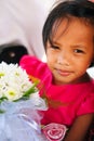 Cute little girl in pink dress holding white flowers bouquet on wedding celebration. Little flower girl at wedding Royalty Free Stock Photo