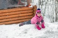 Cute little girl in pink sport suit having fun playing outdoors during snowfall in winter. Children winter seasonal outdoor Royalty Free Stock Photo