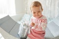 Cute little girl in pink sweater holding christmas present Royalty Free Stock Photo