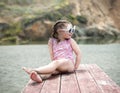 Cute little girl in pink swimsuit looking away Royalty Free Stock Photo