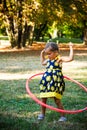 Cute little girl play with hula hoop in park Royalty Free Stock Photo