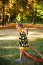 Cute little girl play with hula hoop in park Royalty Free Stock Photo
