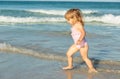 Cute little girl play with water on beach Royalty Free Stock Photo