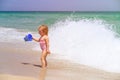 Cute little girl play with water on beach Royalty Free Stock Photo