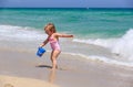 Cute little girl play with water on beach Royalty Free Stock Photo