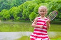 Cute little girl playing badminton on picnic