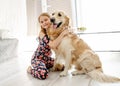 Cute little girl playing with beautiful goden retriever dog