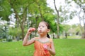 Cute little girl playing bubble in the park Royalty Free Stock Photo