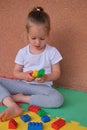 cute little girl playing building blocks lego colorful constructor bricks toys