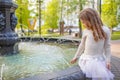 Cute little girl playing by city fountain on hot and sunny summer day. Child having fun with water in summer. Active leisure for k Royalty Free Stock Photo