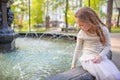 Cute little girl playing by city fountain on hot and sunny summer day. Child having fun with water in summer. Active leisure for k Royalty Free Stock Photo