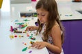 Cute little girl playing with construction toy blocks building a house;  children and toys Royalty Free Stock Photo