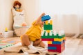 Little girl playing with construction toy blocks building a tower in a sunny kindergarten room Royalty Free Stock Photo