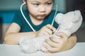 Cute little girl playing doctor or nurse with stethoscope and li Royalty Free Stock Photo