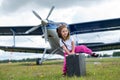 A cute little girl playing on the field by a four-seater private jet dreaming of becoming a pilot Royalty Free Stock Photo