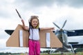 A cute little girl playing on the field by a four-seater private jet dreaming of becoming a pilot Royalty Free Stock Photo