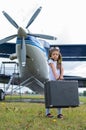 A cute little girl playing on the field by private jet dreaming of becoming a pilot Royalty Free Stock Photo