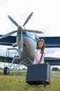 A cute little girl playing on the field by private jet dreaming of becoming a pilot Royalty Free Stock Photo