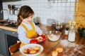 Cute little girl playing with food in the kitchen. Royalty Free Stock Photo